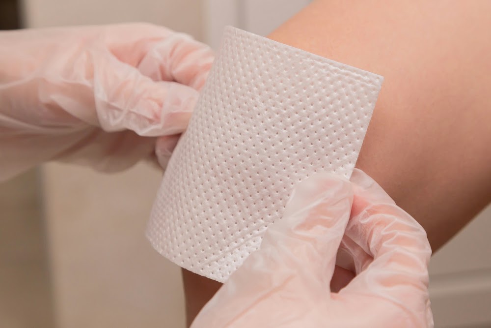 A minor knee wound being cared for with proper first aid cleansing