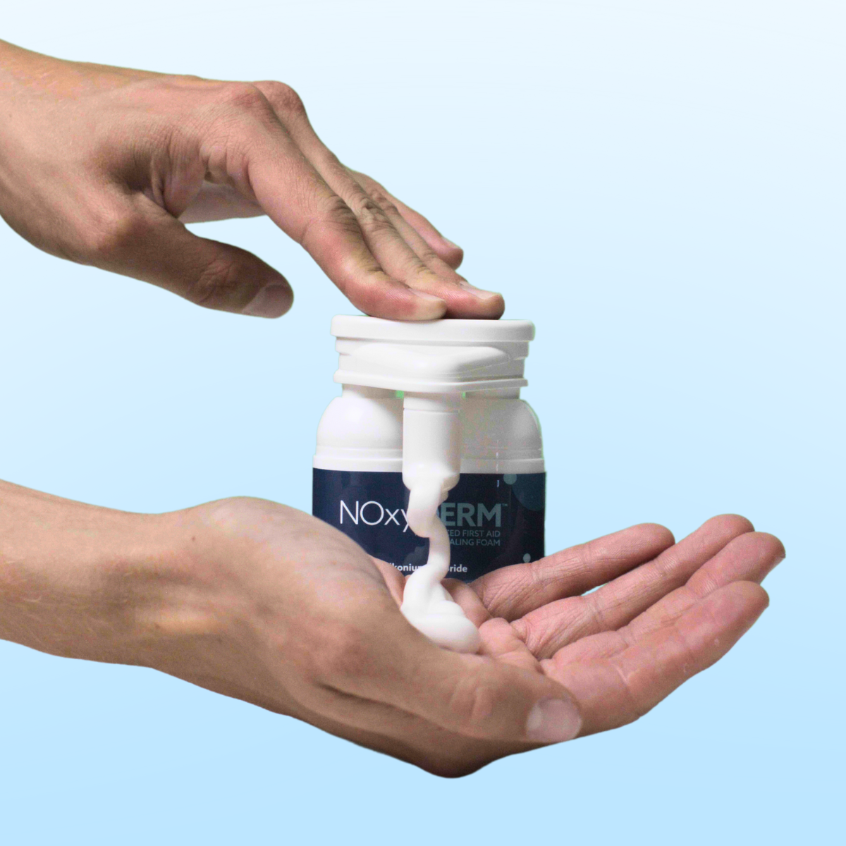 image of a hand pushing down on the foaming antiseptic dispenser