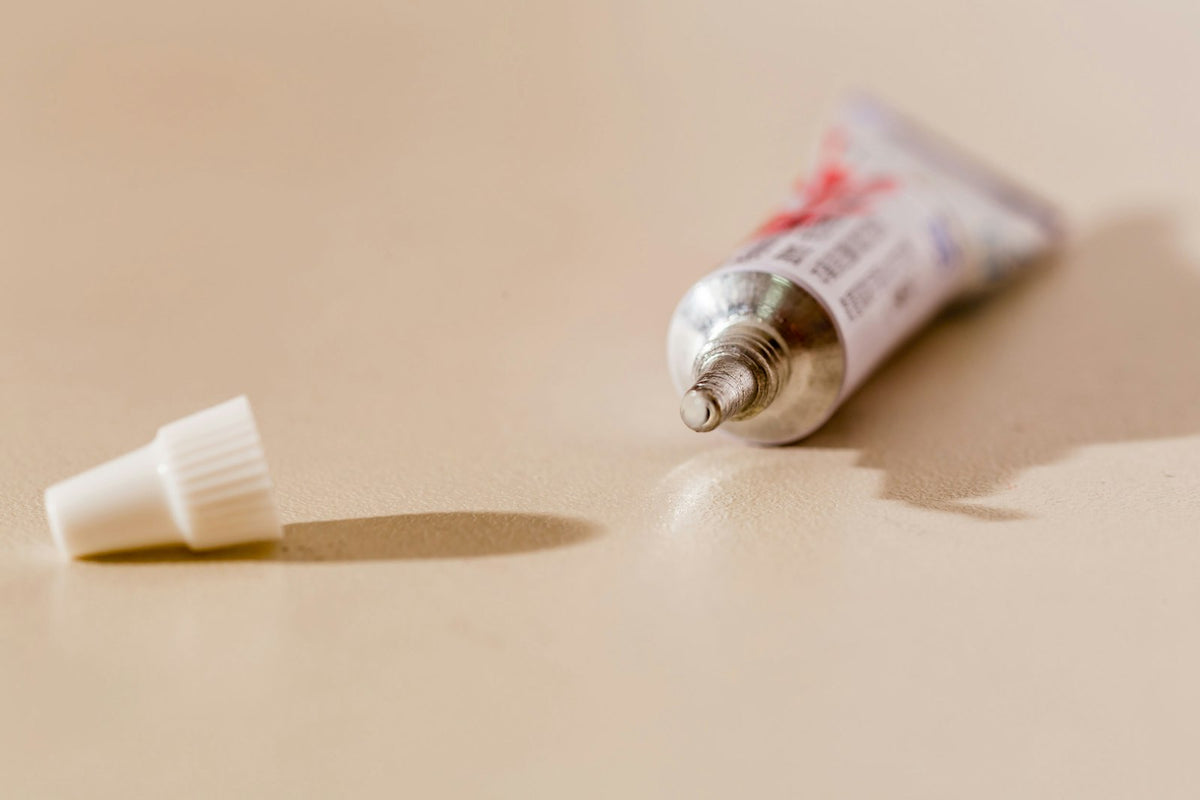 White ointment tube on a light surface