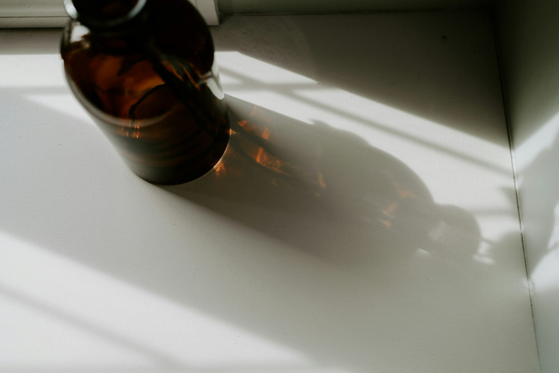 Brown glass bottle on a bright white surface, representing how to check if hydrogen peroxide has expired